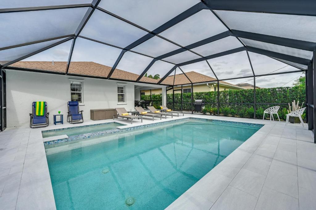 an indoor swimming pool with a retractable roof at Central Naples Home with Private Pool, Spa and Lanai! in Naples