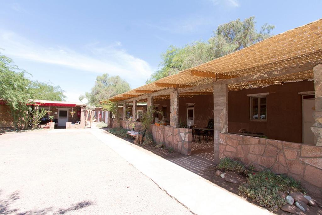 an old building with a tile roof on a street at Quinta Adela Bed & Breakfast in San Pedro de Atacama