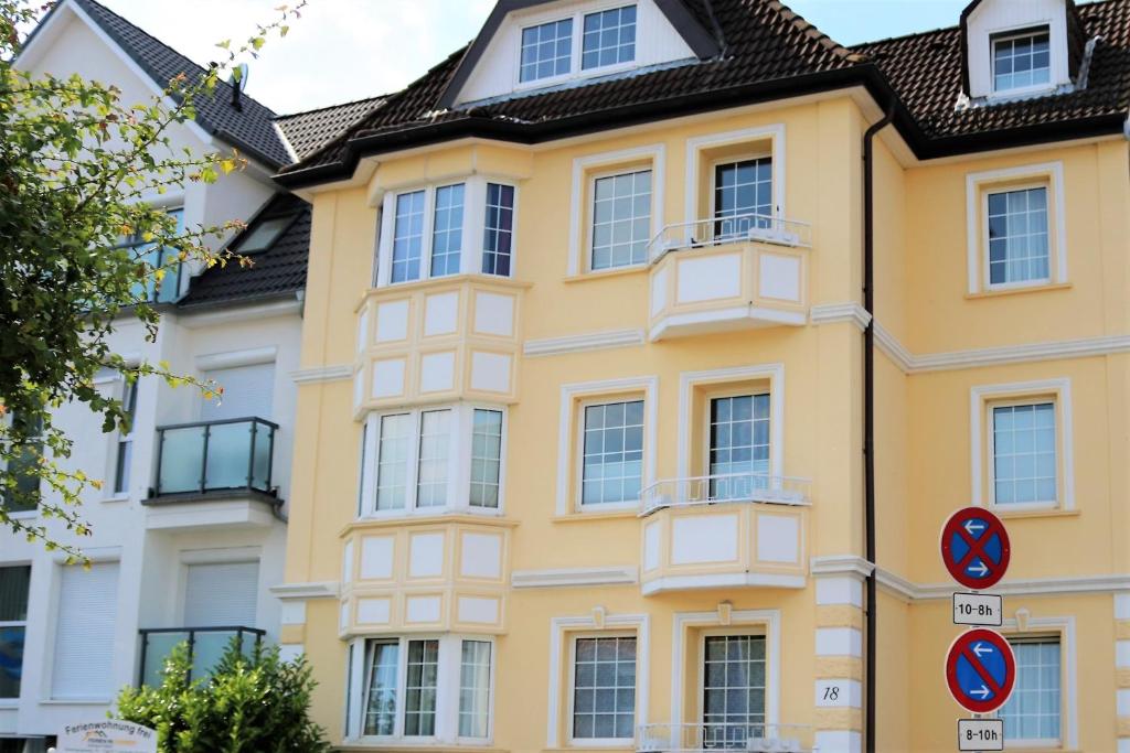 a yellow building with a black roof at Haus Nordsee 06 in Duhnen