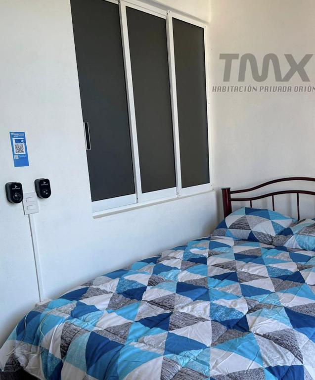 Letto o letti in una camera di TMX HOSTAL