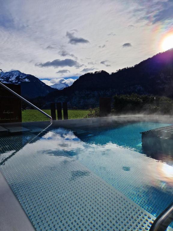 a hot tub with a view of the mountains at SALZANO Apartments in Interlaken