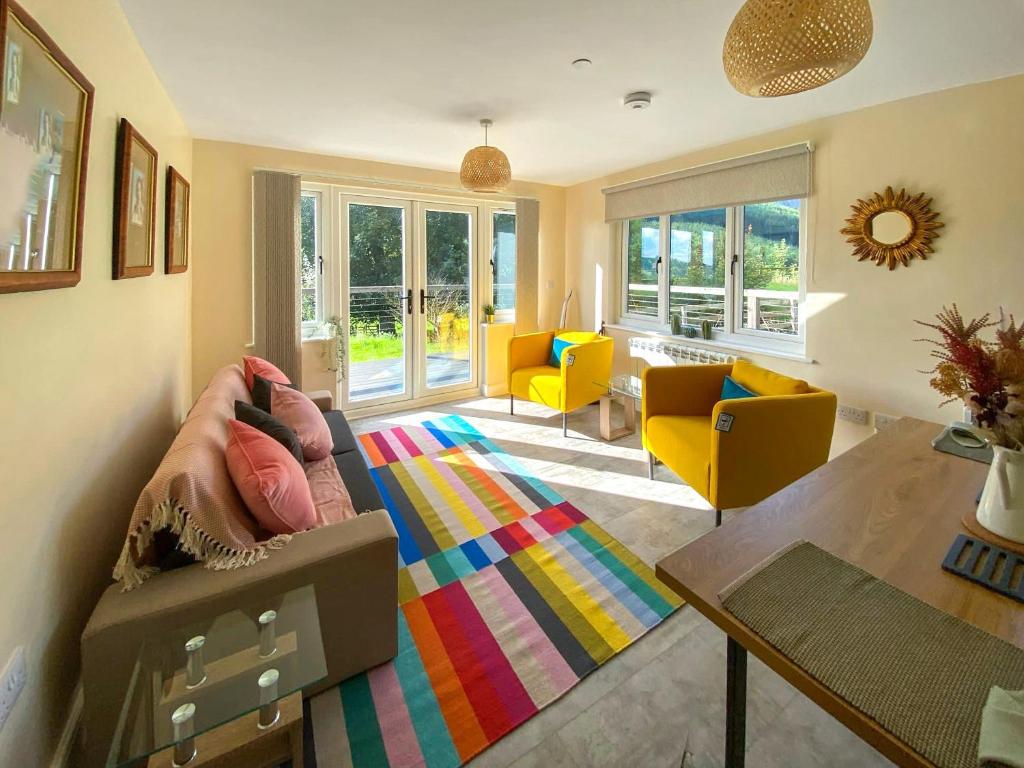 a living room with a couch and a table at The Old Stables in Presteigne