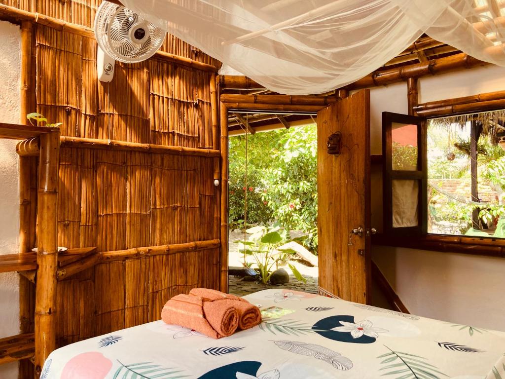 a bedroom with a bed and a window at La Caleta in Mompiche