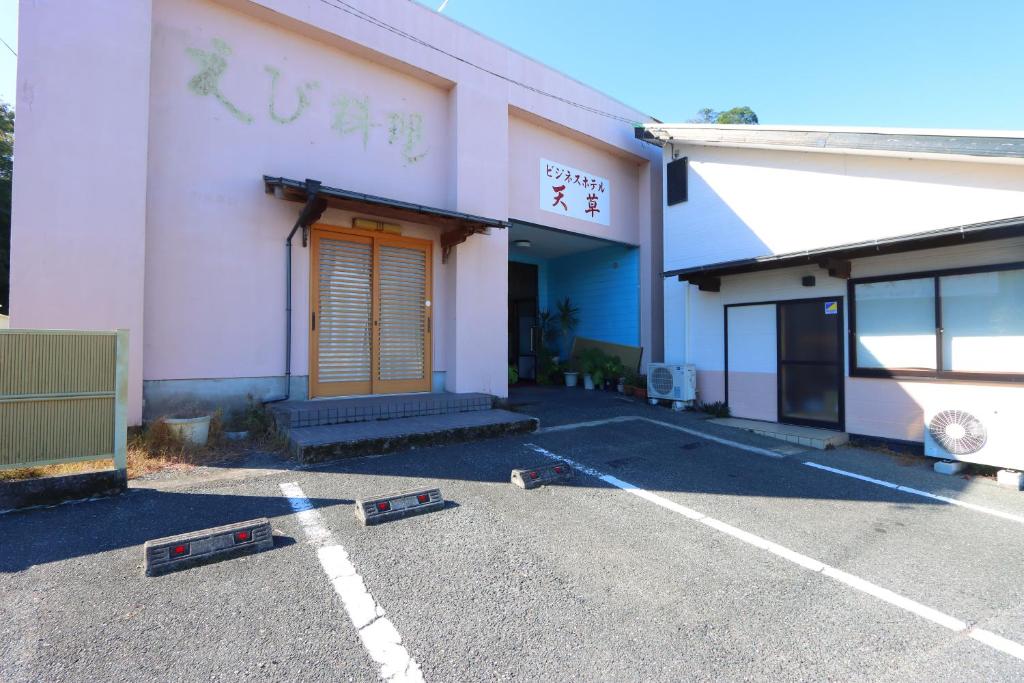 an empty parking lot in front of a building at Business Hotel Amakusa in Yanagi