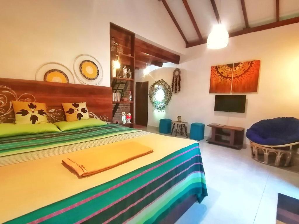 a bedroom with a large bed and a tv at Villa Aroma, Katunayaka in Minuwangoda