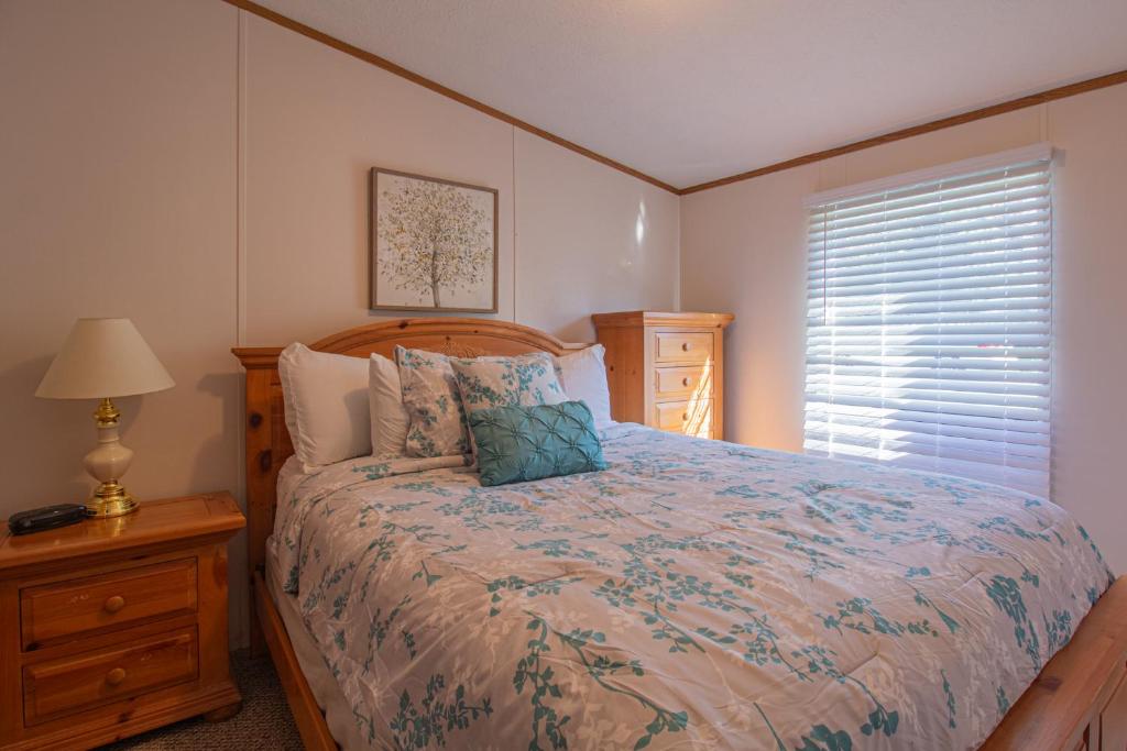 a bedroom with a large bed and a window at Stay In Ohiopyle near the GAP Trail - Ohiopyle, PA in Ohiopyle