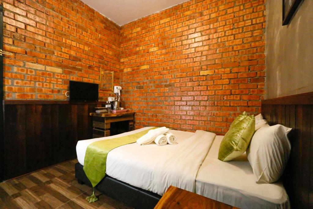 Postel nebo postele na pokoji v ubytování Anggun Hotel