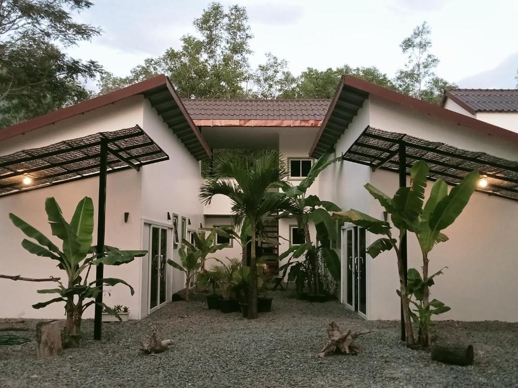 a rendering of a house with palm trees at Little Escape Guesthouse Nesat in Phumĭ Chroŭy Svay
