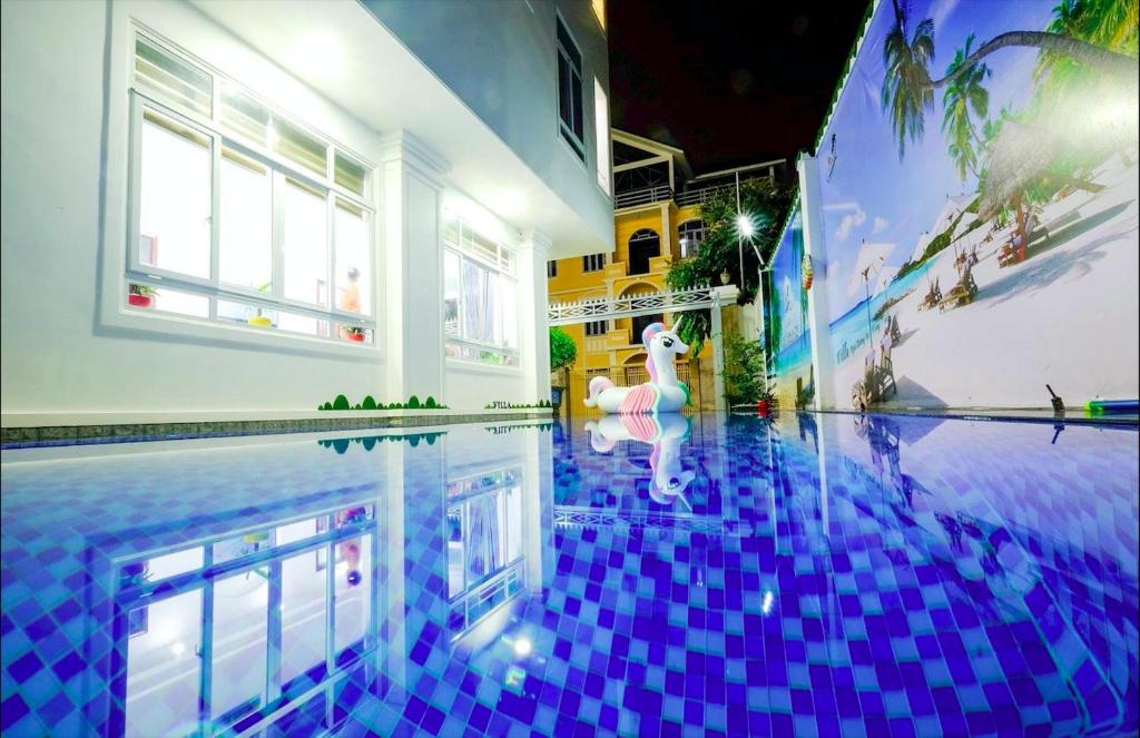 a swimming pool with a swan in the middle of it at The Luxury Pool Villa Vung Tau in Vung Tau