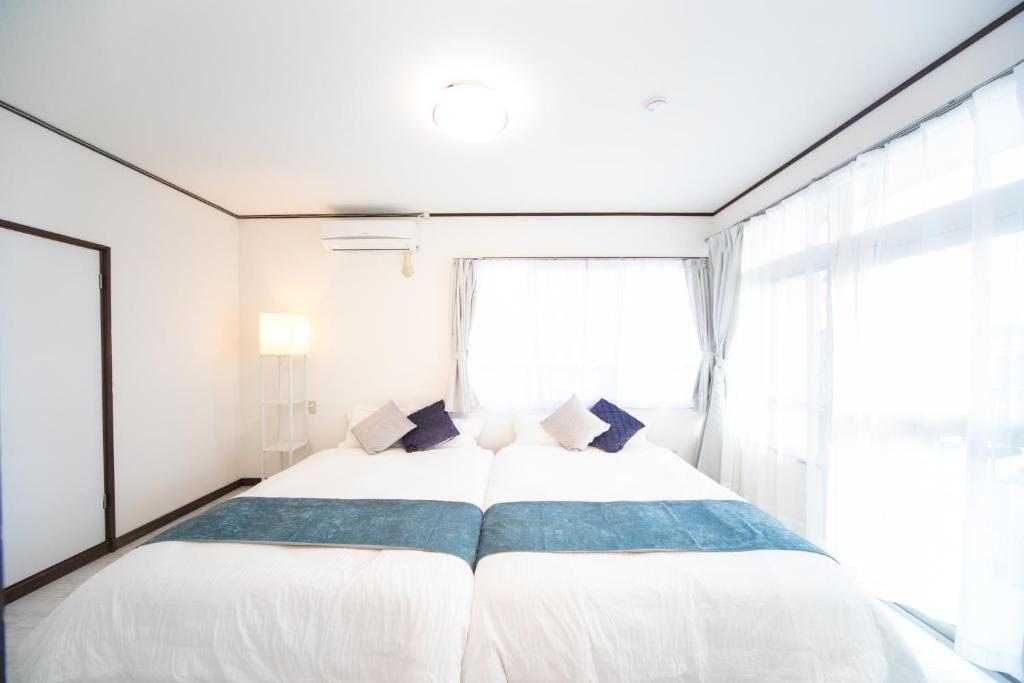 Postel nebo postele na pokoji v ubytování 菰野ガーデンリゾート