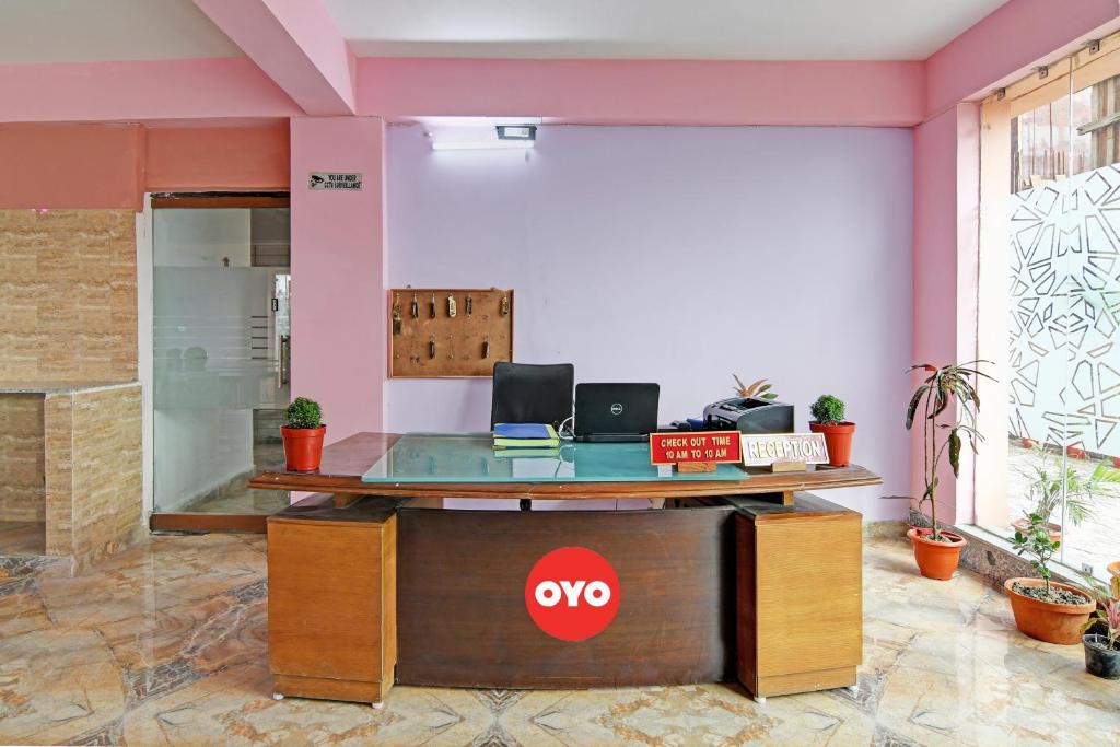 una oficina con un escritorio con un cartel de aoops en ella en The Blue Pearl Hotel en Calcuta