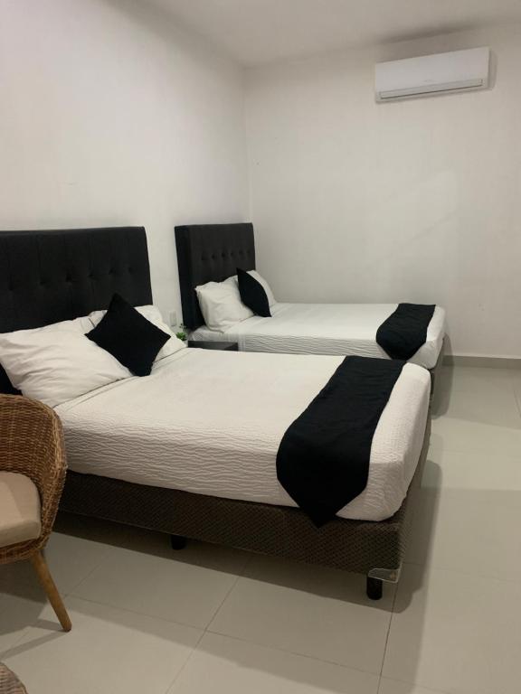 Postel nebo postele na pokoji v ubytování HOTEL SOÍ BACALAR