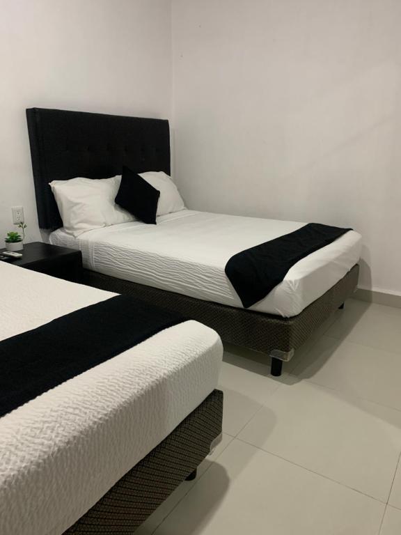 Postel nebo postele na pokoji v ubytování HOTEL SOÍ BACALAR