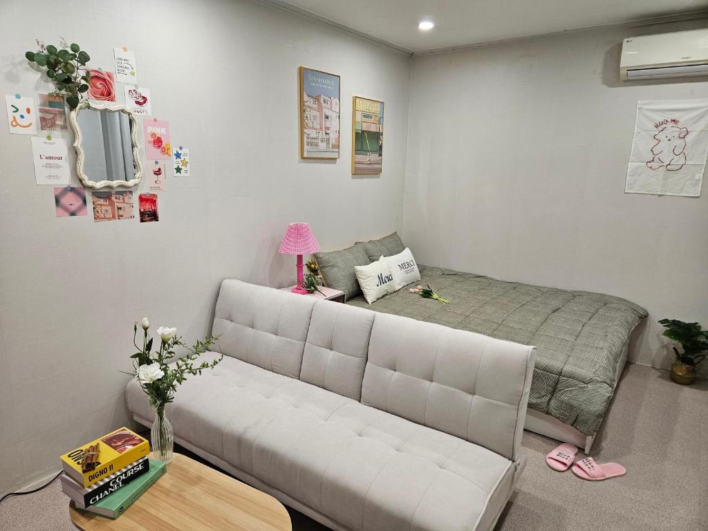 a living room with a couch and a bed at Seoul Stay in Seoul