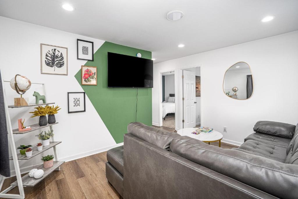 a living room with a couch and a flat screen tv at Centrally Located 3BD Urban Oasis in Indianapolis
