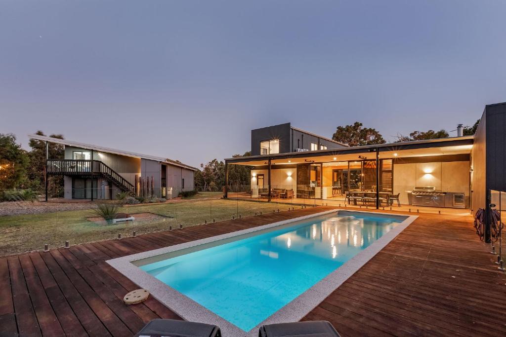 a swimming pool in the backyard of a house at Eagle Rise Plus Studio in Dunsborough