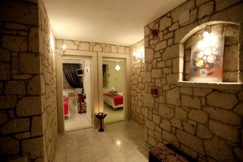 a hallway of a room with a stone wall at Lodos Butik Hotel in Alaçatı