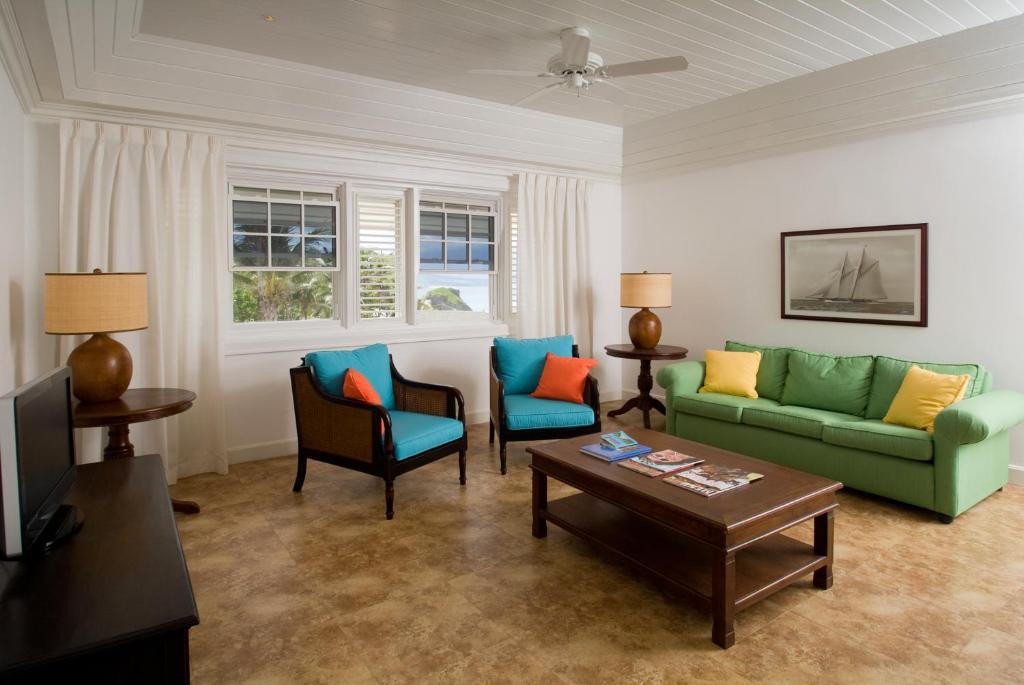 a living room with a couch and chairs and a table at The Atlantis Historic Inn in Saint Joseph