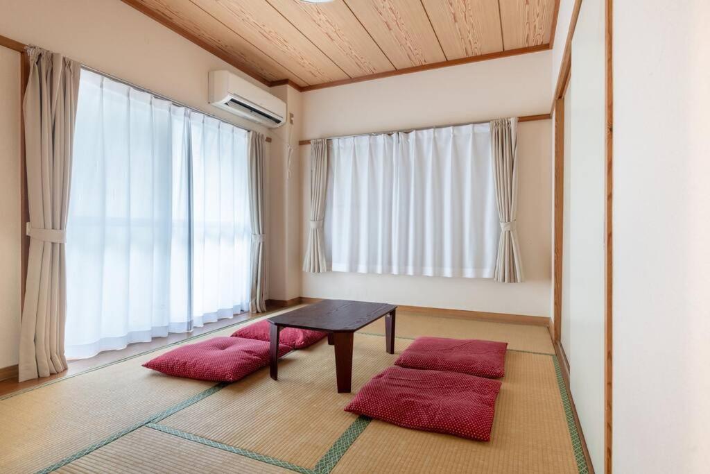a room with a table and two red cushions at Tokyo Skytree Residence Inn (F2) in Tokyo