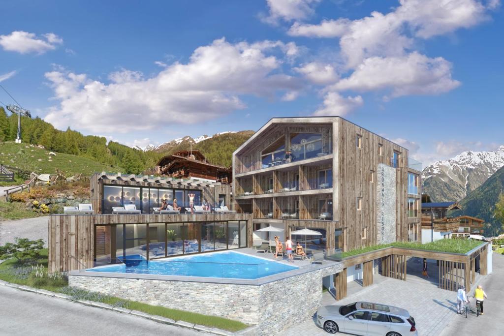 un edificio con una piscina di fronte di Grünwald Resort Sölden a Sölden