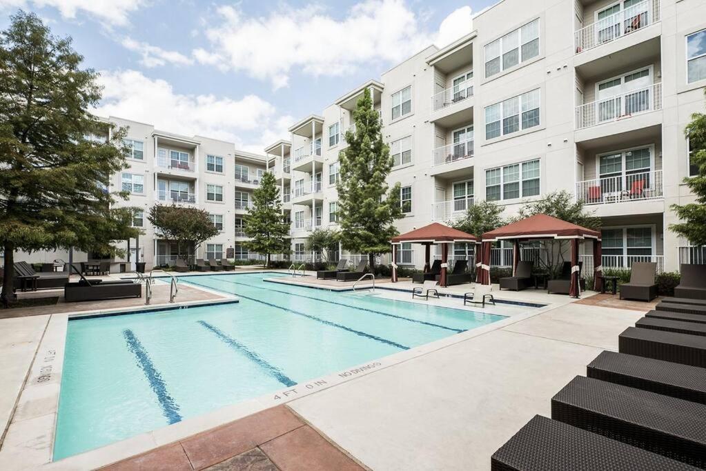 an image of a swimming pool in front of a building at Your 1Br and LR Home Away From Home in Dallas