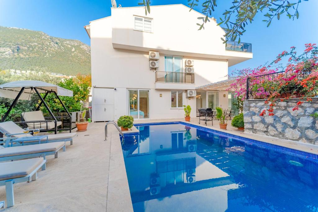 a villa with a swimming pool and a house at Skyler Villaları in Kas