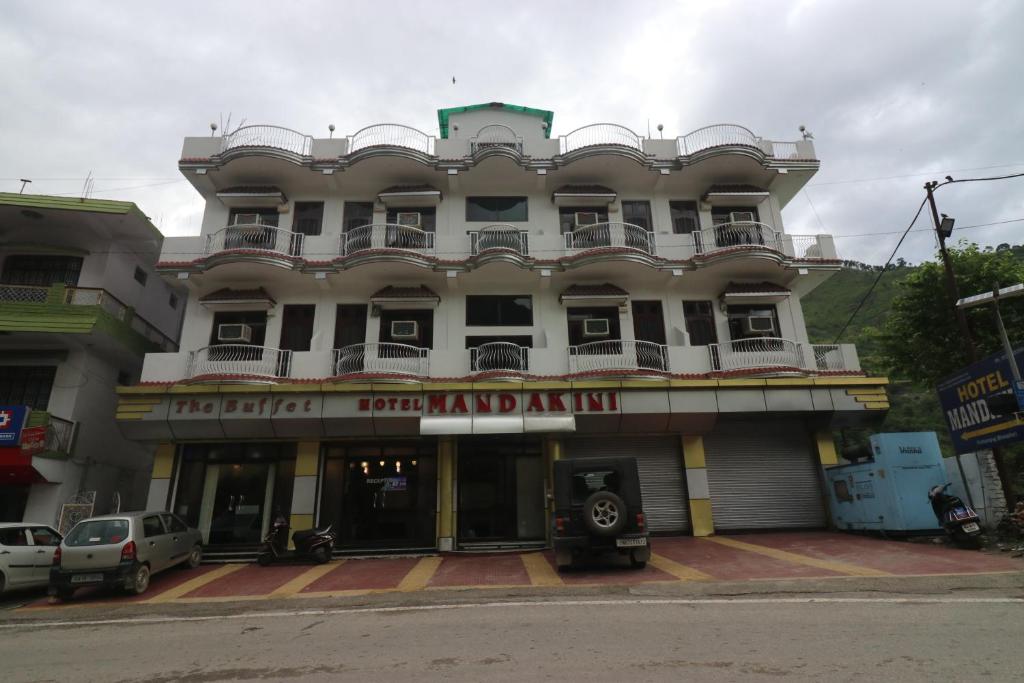 a large white building with a sign that reads centrallandamine inn at Hotel Mandakini in Rudraprayāg