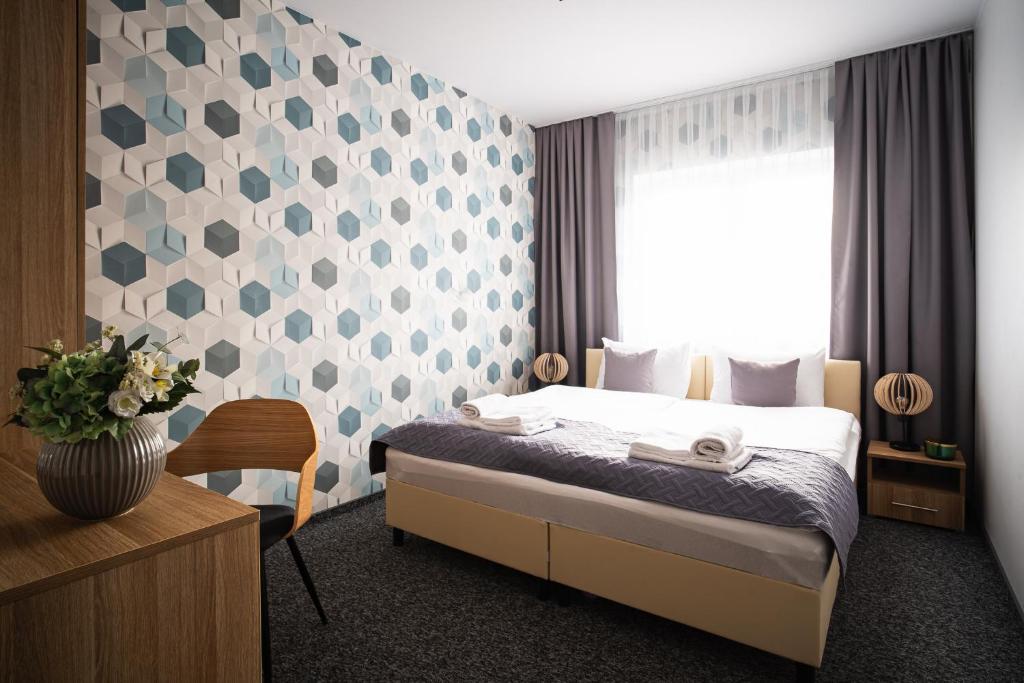 a hotel room with a bed and a window at Diament Ruda Śląska in Ruda Śląska