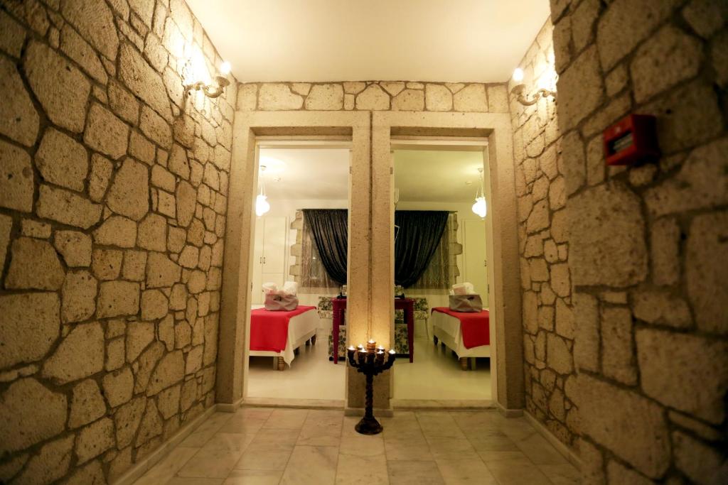 a hallway with a room with two beds and a mirror at Lodos Butik Hotel in Alaçatı