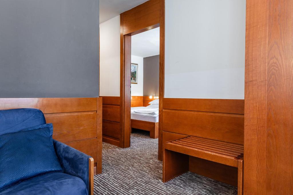 Postel nebo postele na pokoji v ubytování Hotel Kranjska Gora