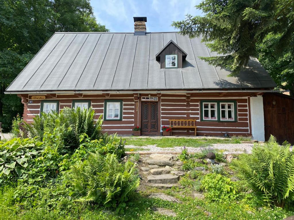 una pequeña casa de madera con techo en Chalupa Šárka, en Dolni Dvur