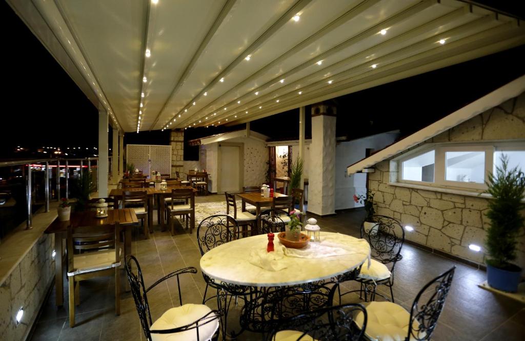 a restaurant with a table and chairs and lights at Lodos Butik Hotel in Alaçatı