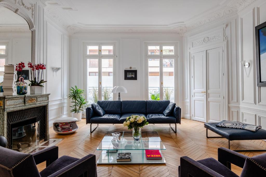 a living room with a couch and a fireplace at Veeve - Blue Majesty in Paris