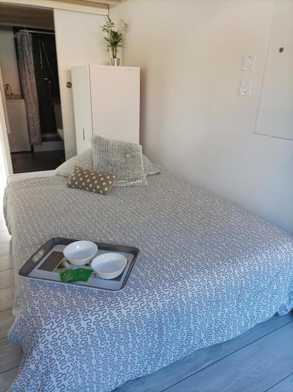 a tray of food on top of a bed at Studio du Pouverel in La Garde