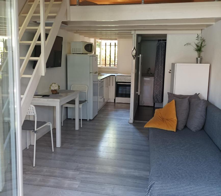 a small living room with a couch and a kitchen at Studio du Pouverel in La Garde