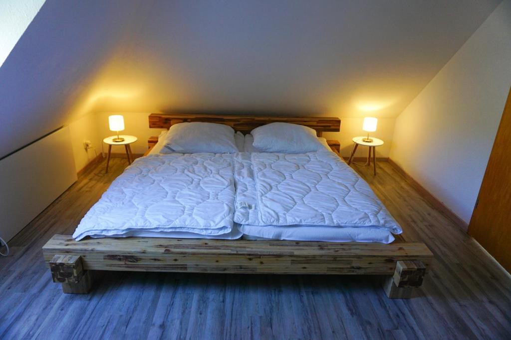 um quarto com uma cama com 2 candeeiros em ambos os lados em „Kiekut“ Ferienwohnung em Fehmarn
