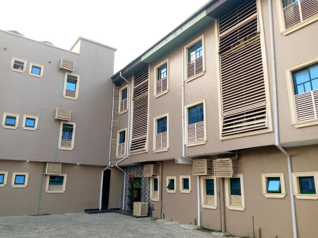 an apartment building with shutters on the side at Exclusive mansion lekki phase 1 in Ilado