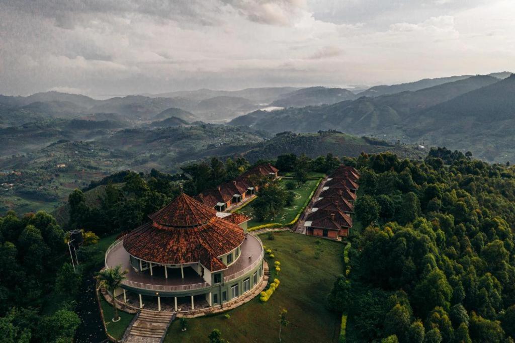 an aerial view of a building with mountains in the background at Nyungwe Hill View Hotel in Rwumba