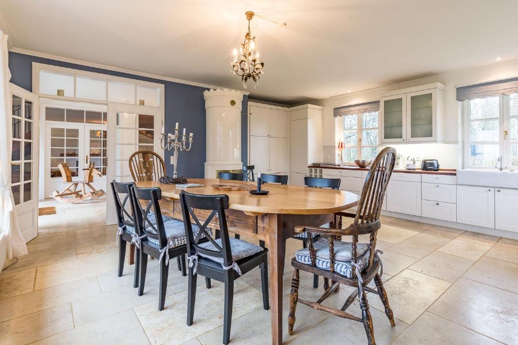 a kitchen with a wooden table and chairs at Landhaus Brook in Brook