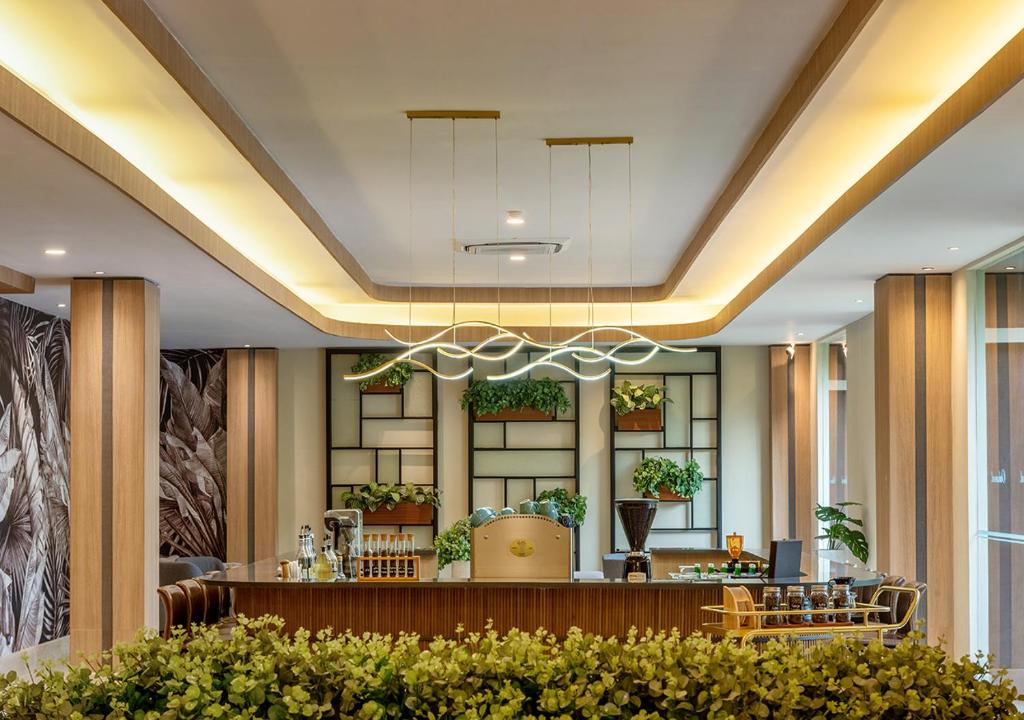 a lobby of a hotel with a bar at Oakwood Hotel & Apartments Taman Mini Jakarta in Jakarta