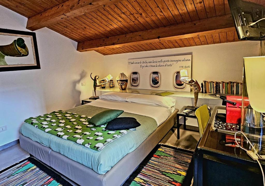 a bedroom with a large bed and a desk at La Foresteria Garden Boutique B&B in Catania
