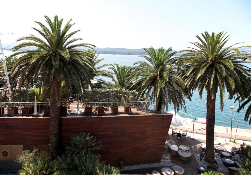 a view of a resort with palm trees and the water at City Center Apartments in Tivat