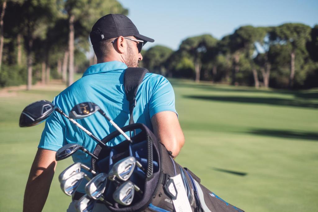 a man with a backpack standing next to a golf course at The View Agadir in Agadir