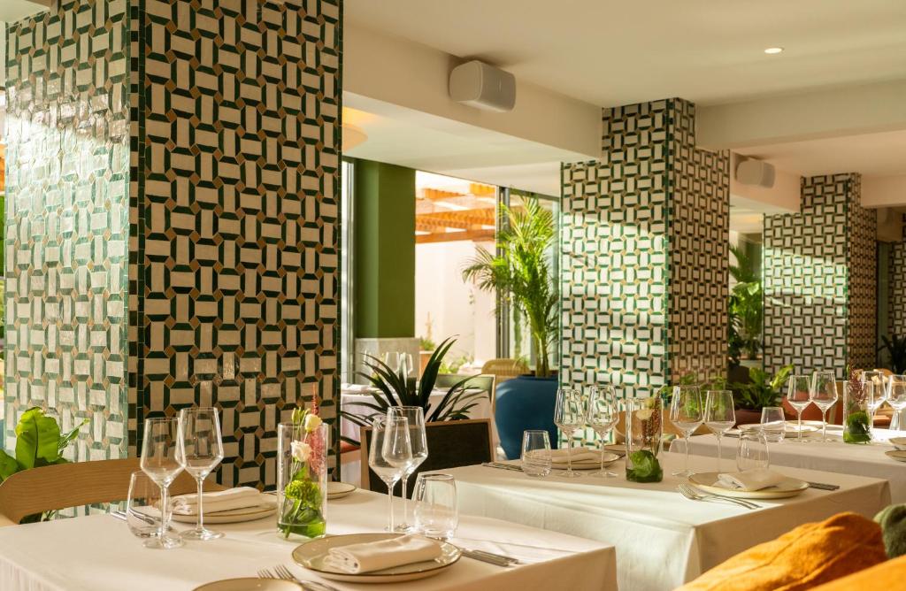a dining room with tables with white tablecloths at The View Agadir in Agadir