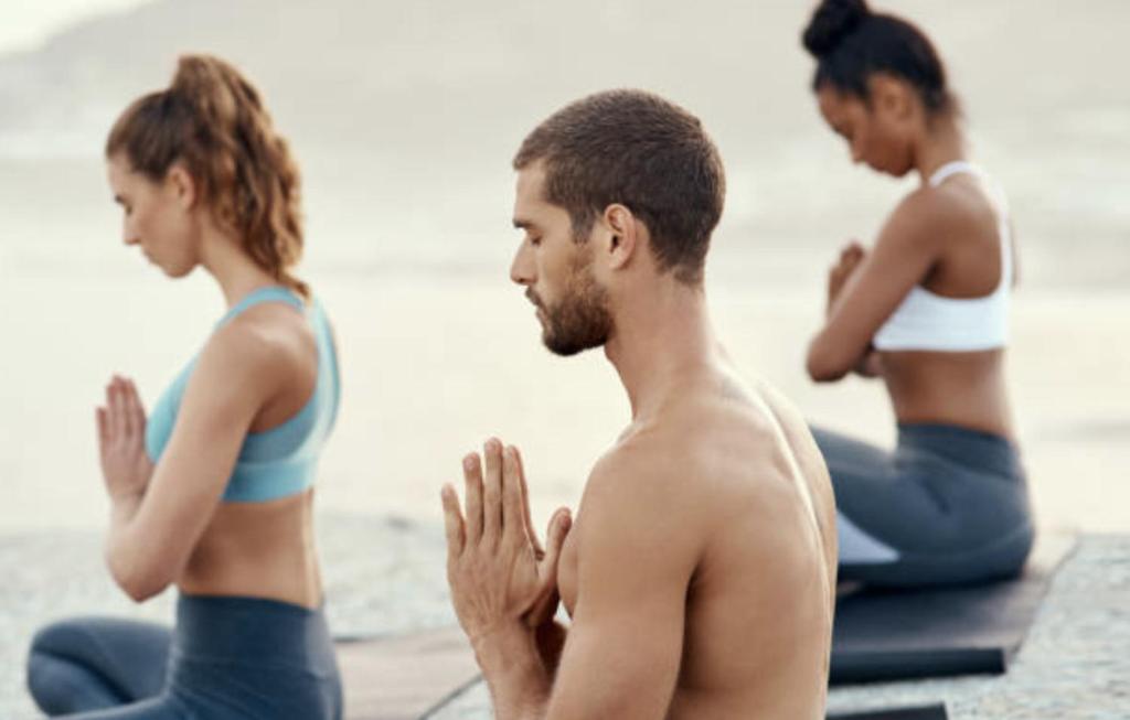 a group of people doing yoga on the beach at The View Agadir in Agadir