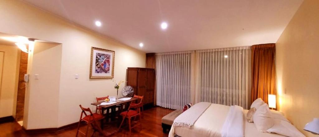 a hotel room with a bed and a desk in it at Entire Studio-Apartment De Luxe in Lima