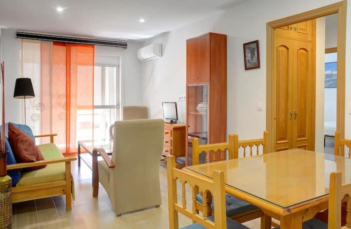 a living room with a dining room table and chairs at Apartamento amplio in Seville