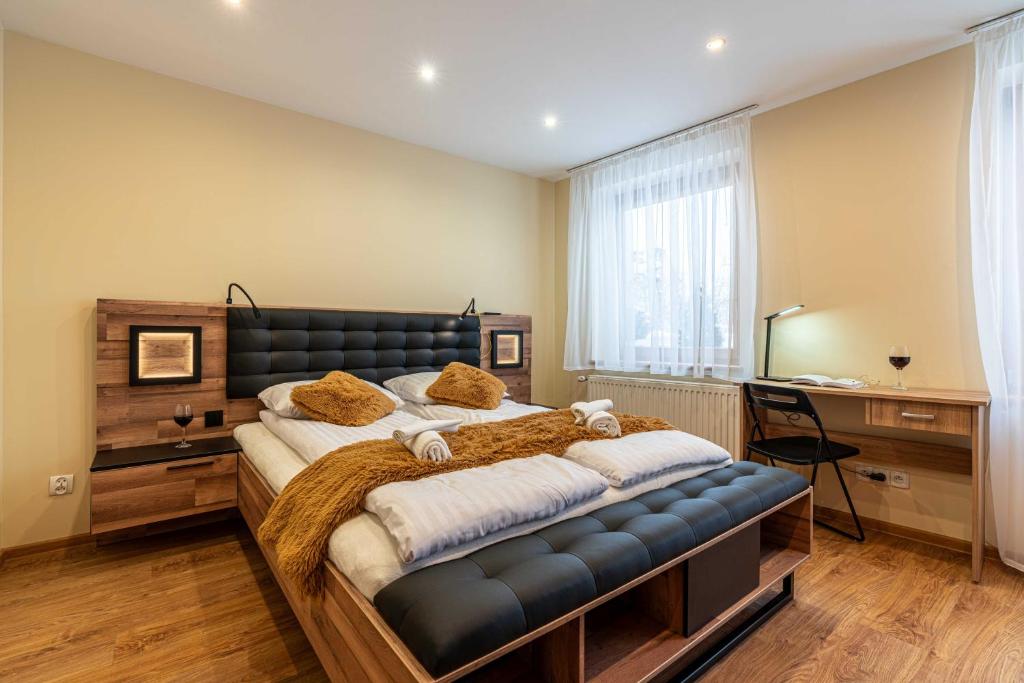 a bedroom with a large bed and a desk at Spora Chata in Nowy Targ