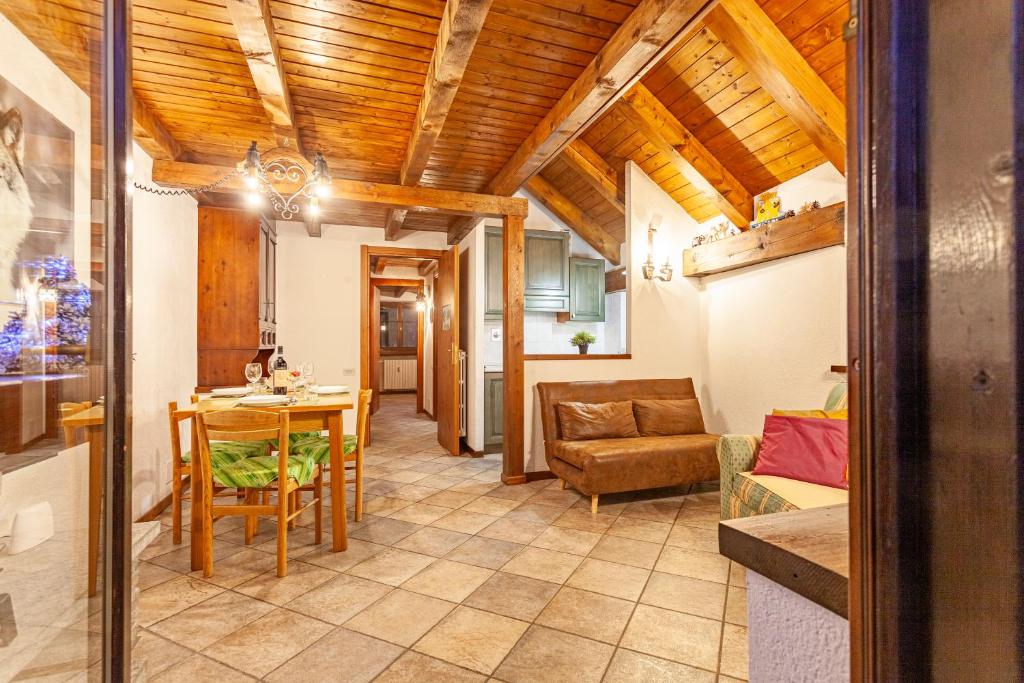 a kitchen and living room with a table and a couch at Casa Leonida in Bardonecchia