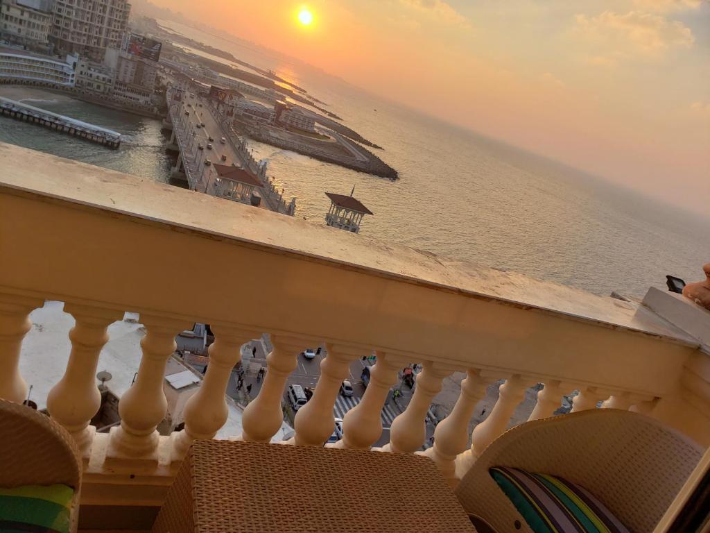 a balcony with a cruise ship in the water at Stanley Bridge Apartment in Alexandria